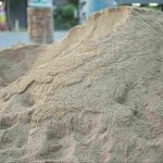 Washed construction sand piled for building and landscaping projects, showing fine, clean sand material ready for use.